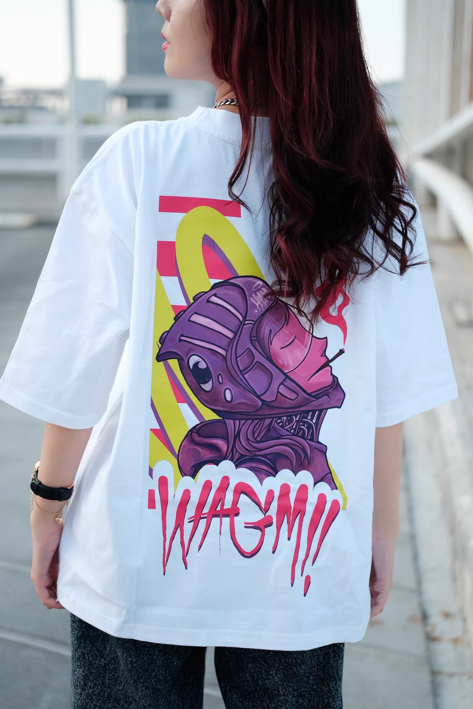 Rear view of a woman wearing an oversized white T-shirt with a colorful character graphic